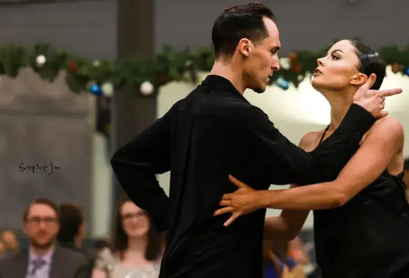 Couple in close hold during an International Latin dance routine in Ottawa at DQ Ballroom & Fitness