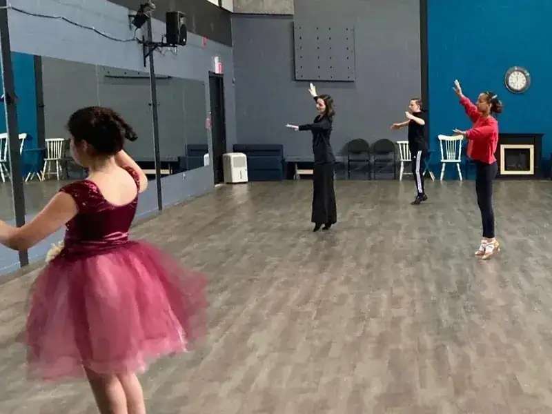 Children practicing arm positions with their instructor in a kids dance class in Ottawa at DQ Ballroom & Fitness